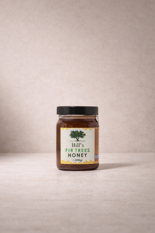 Jar of Bill's Fir Trees Honey, 450 g, with black lid and olive tree label on a neutral background